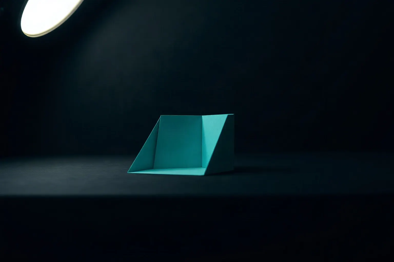 A paper pop-up model half unfolded on a dark desk — illustration for SPA SEO